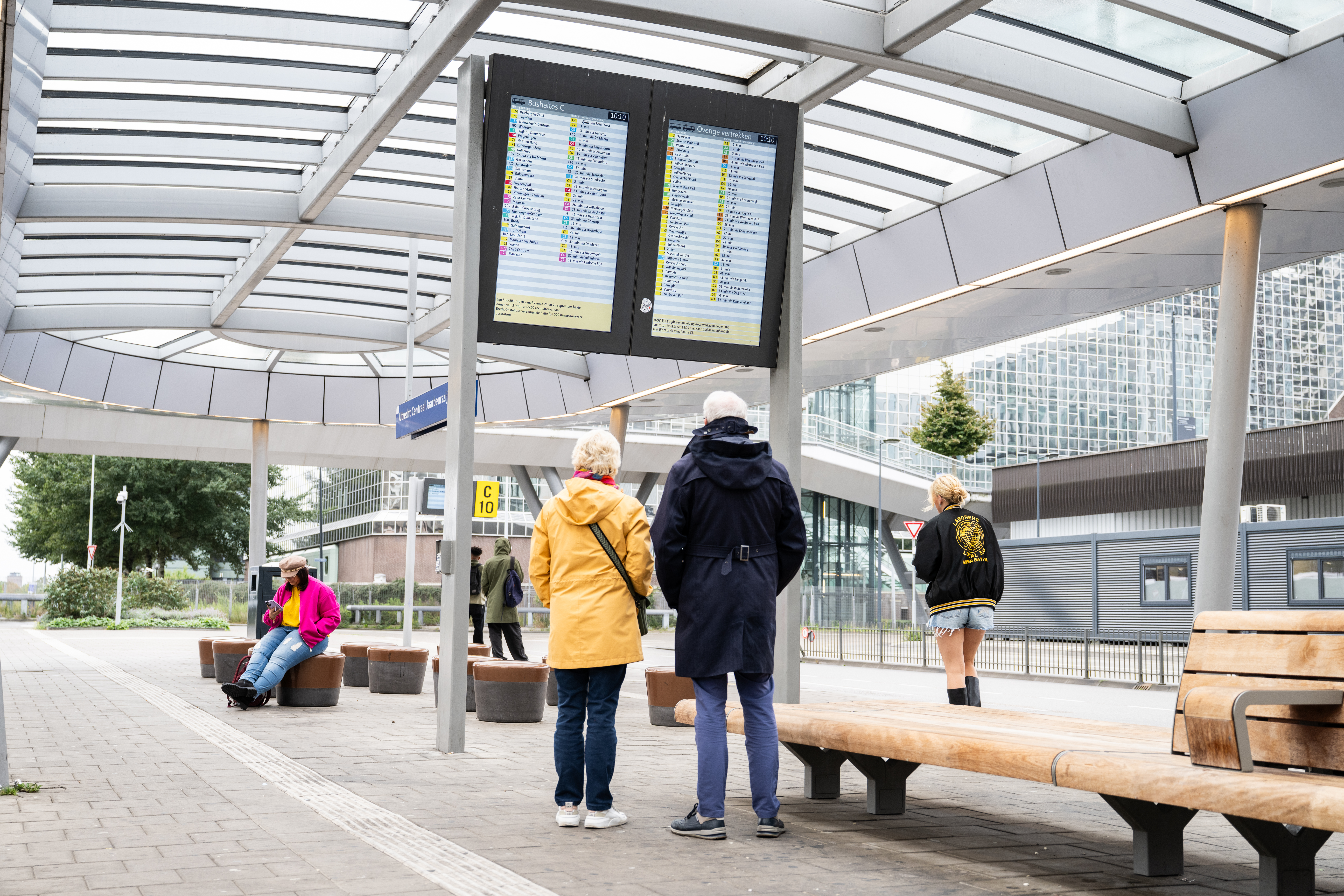 Service sign on a platform. Passengers are looking at it.