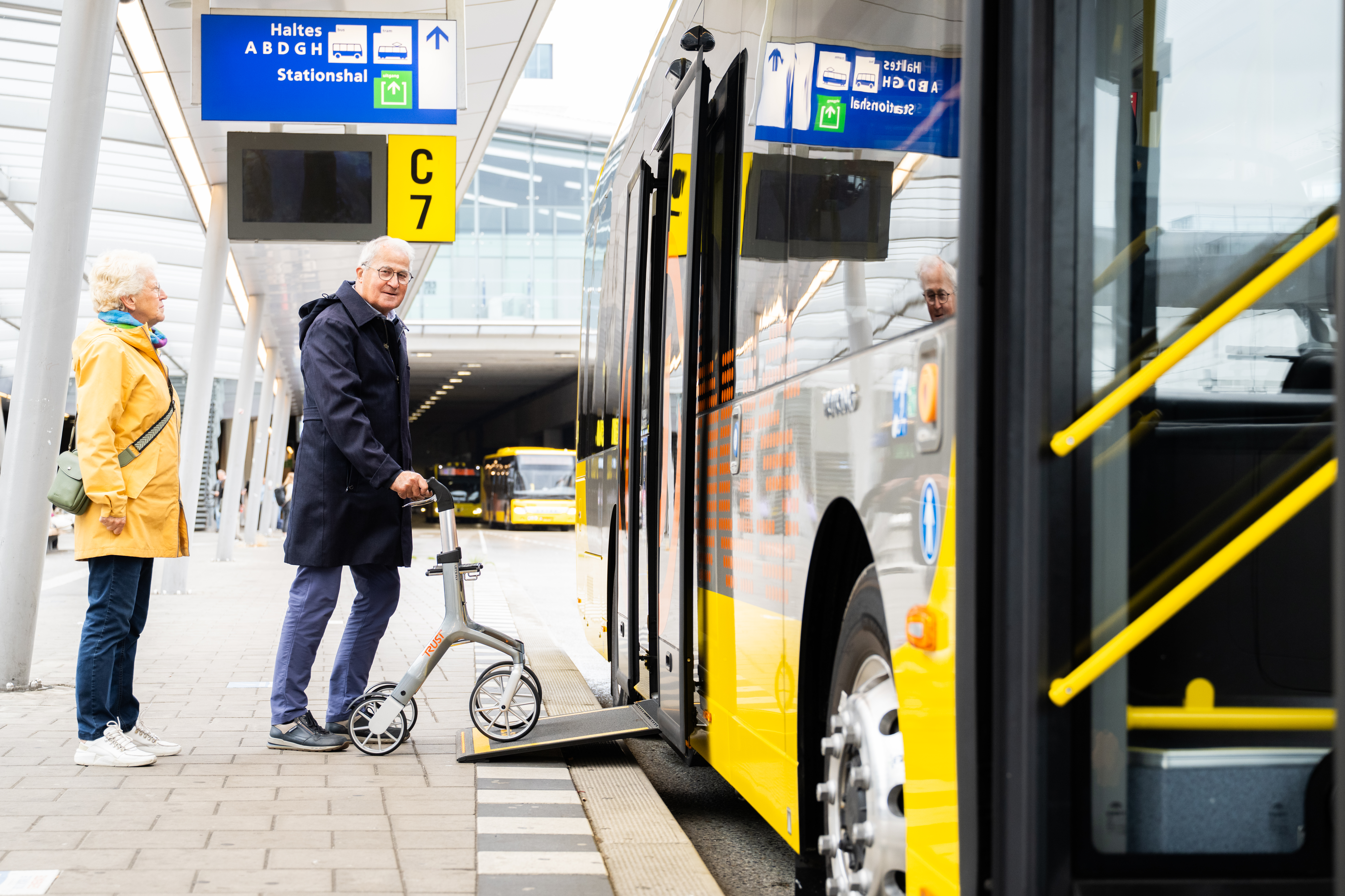 Man with a walker gets on the bus