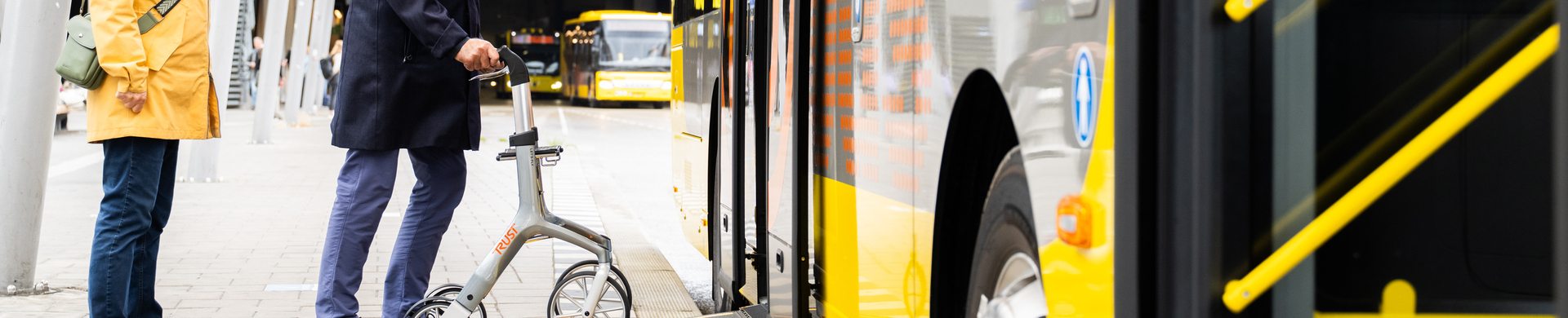 Man with a walker gets on the bus